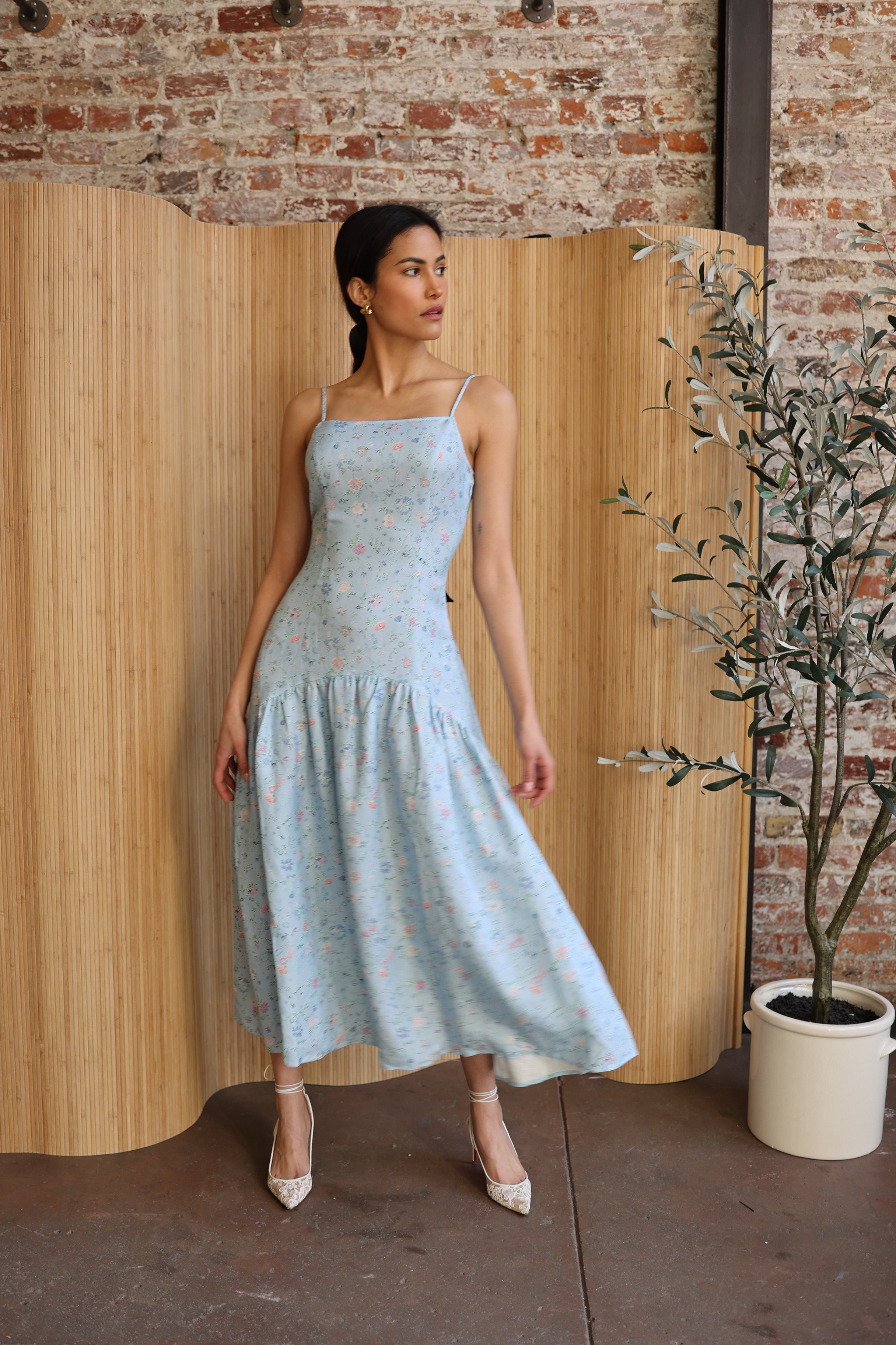 Light blue, floral sundress with spaghetti straps and a tiered skirt, ideal for summer or spring wear, purchase at SISTER NY