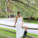 White eyelet dress with breathable fabric, it's fitted through the bodice to cinch the waist and has a sweetheart neckline with underwired cups. The barely-there straps adjust for the perfect fit and we love how the gathering adds pretty volume to the midi skirt giving you the perfect twirl. Fully lined for comfort with a back zip for easy-on.