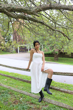 White eyelet dress with breathable fabric, it's fitted through the bodice to cinch the waist and has a sweetheart neckline with underwired cups. The barely-there straps adjust for the perfect fit and we love how the gathering adds pretty volume to the midi skirt giving you the perfect twirl. Fully lined for comfort with a back zip for easy-on.