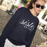 Made in NYC from 100% cotton, this navy crewneck sweatshirt blends comfort and style with its signature sister script and bold “NEW YORK” print. A relaxed fit and soft fleece make it perfect year-round.